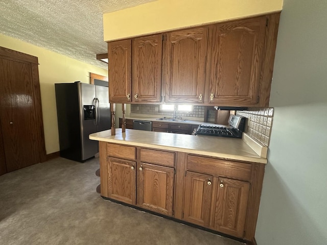 kitchen featuring decorative backsplash, brown cabinets, stainless steel appliances, and light countertops