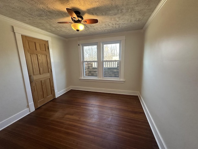 unfurnished room featuring baseboards, dark wood-style flooring, and ornamental molding