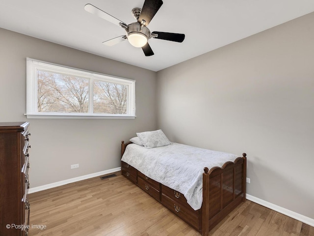 bedroom with visible vents, baseboards, light wood-style floors, and a ceiling fan