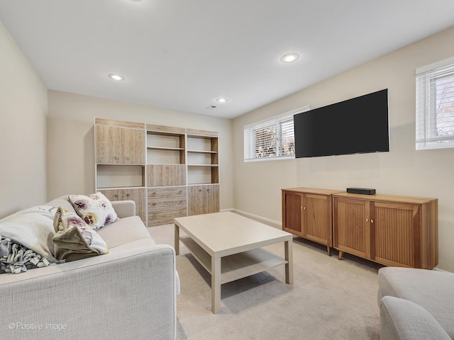 living area with recessed lighting and light carpet