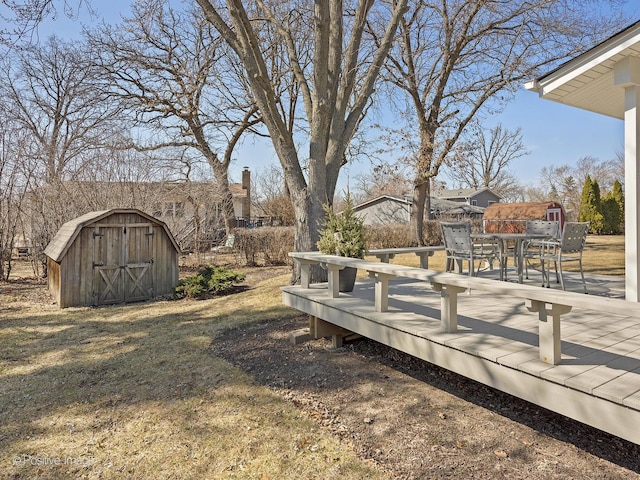 view of yard with a storage shed, outdoor dining area, and an outbuilding