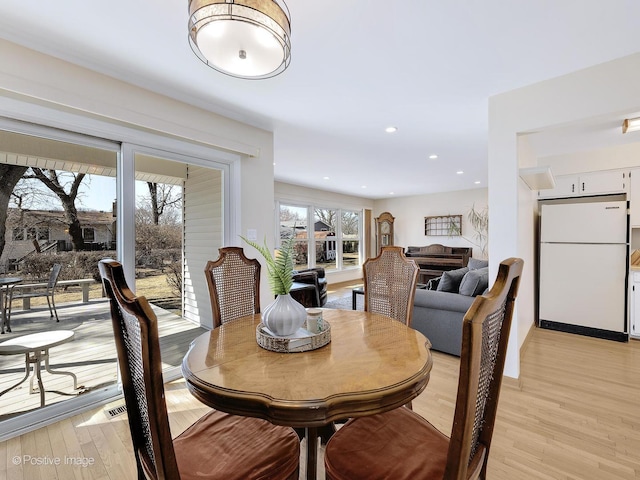 dining area featuring recessed lighting, visible vents, plenty of natural light, and light wood finished floors