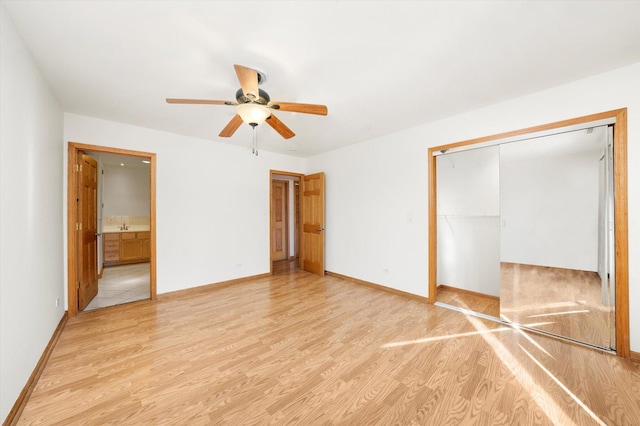 unfurnished bedroom featuring a closet, light wood-style flooring, and baseboards