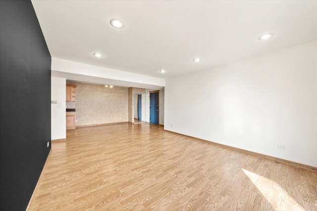 unfurnished room featuring recessed lighting, baseboards, and light wood finished floors