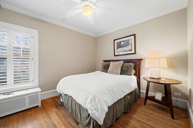 2855 Sheridan Pl, Evanston, IL 60201 - bedroom featuring wood finished floors, crown molding, radiator heating unit, and ceiling fan