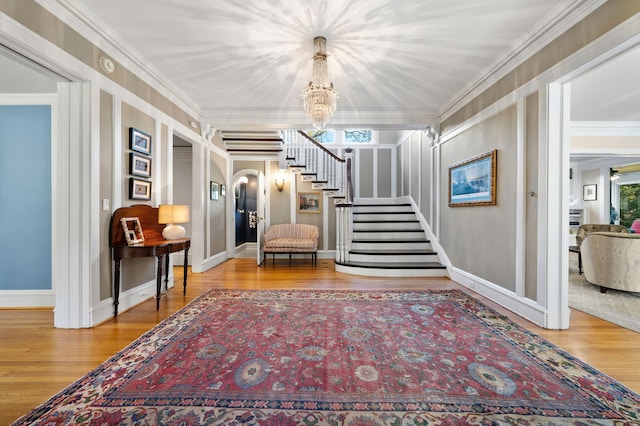 2855 Sheridan Pl, Evanston, IL 60201 - entryway featuring stairway, wood finished floors, a chandelier, and ornamental molding