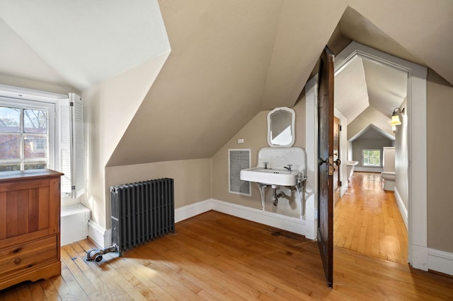 2855 Sheridan Pl, Evanston, IL 60201 - additional living space featuring radiator heating unit, vaulted ceiling, and hardwood / wood-style floors