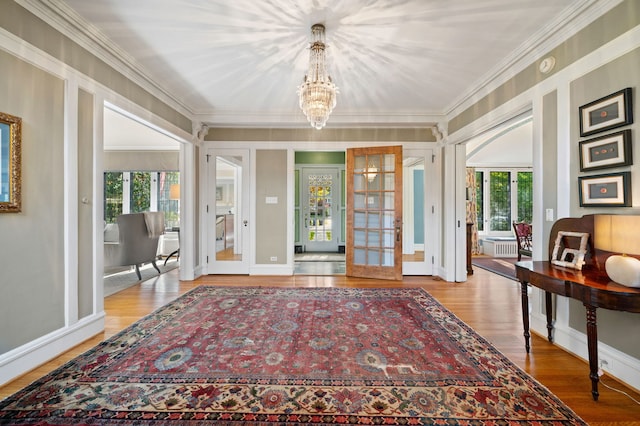 2855 Sheridan Pl, Evanston, IL 60201 - entrance foyer featuring french doors, crown molding, a chandelier, plenty of natural light, and wood finished floors