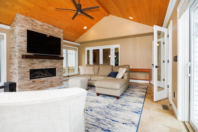 1208 Broad Creek Rd, Bloomington, IL 61704 - living room with french doors, wooden ceiling with exposed beams, ceiling fan, light tile patterned floors, and a stone fireplace