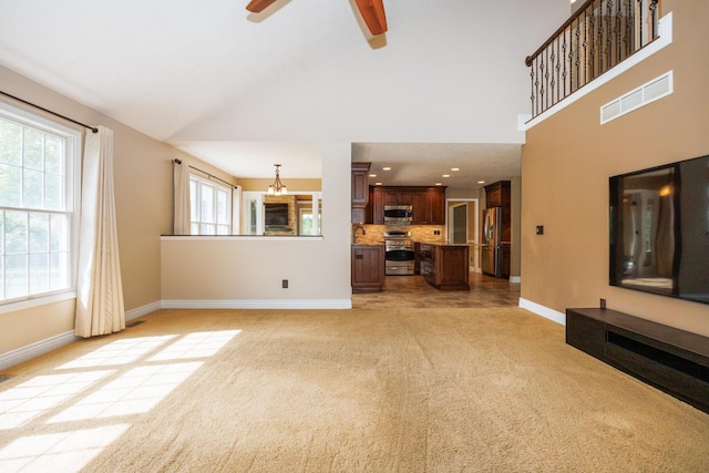 1208 Broad Creek Rd, Bloomington, IL 61704 - unfurnished living room with baseboards, light colored carpet, ceiling fan, high vaulted ceiling, and a sink