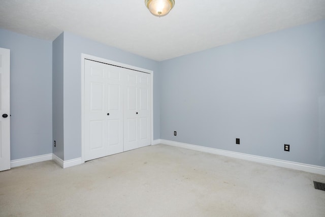 1208 Broad Creek Rd, Bloomington, IL 61704 - unfurnished bedroom with light colored carpet, baseboards, and a closet