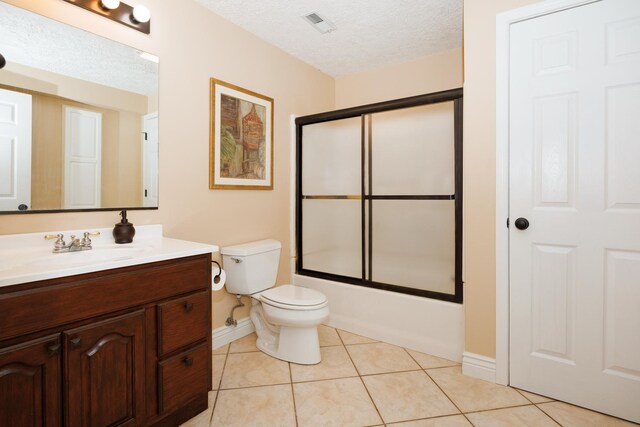 1208 Broad Creek Rd, Bloomington, IL 61704 - bathroom with vanity, baseboards, toilet, bath / shower combo with glass door, and tile patterned floors