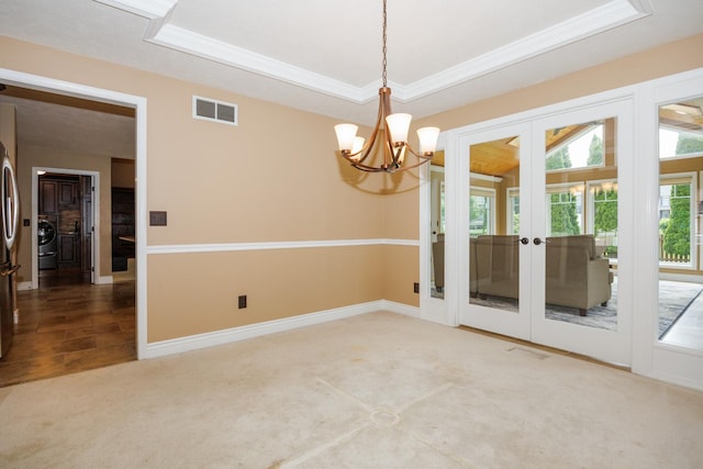 1208 Broad Creek Rd, Bloomington, IL 61704 - unfurnished room featuring french doors, washer / clothes dryer, carpet flooring, a chandelier, and baseboards