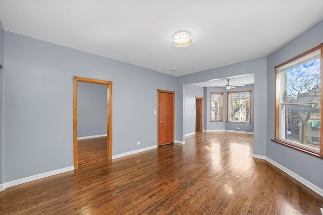 unfurnished room with baseboards and wood finished floors