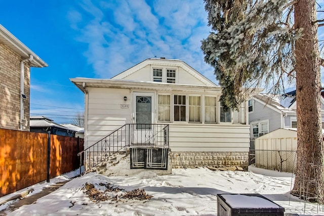 bungalow-style home featuring fence