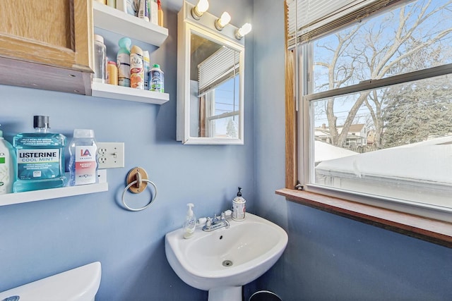 bathroom featuring toilet and a sink