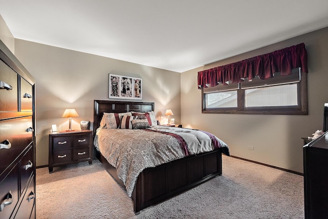 bedroom featuring baseboards and light carpet