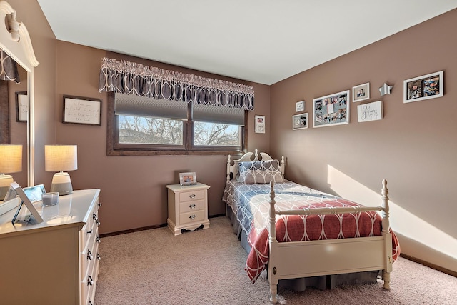 bedroom featuring baseboards and light colored carpet