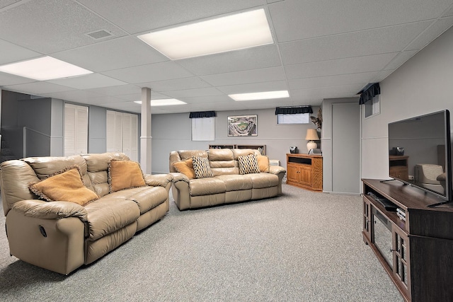 living area featuring a drop ceiling, visible vents, and carpet