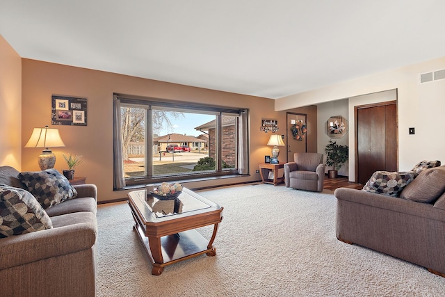 living room with visible vents and carpet flooring