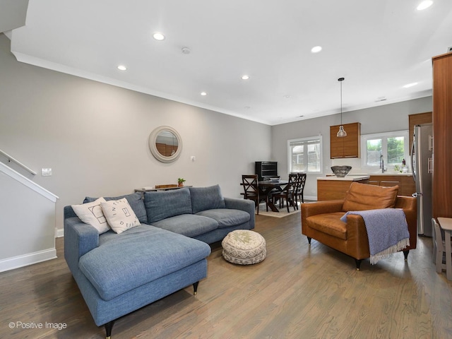 living room with dark wood finished floors, recessed lighting, baseboards, and ornamental molding