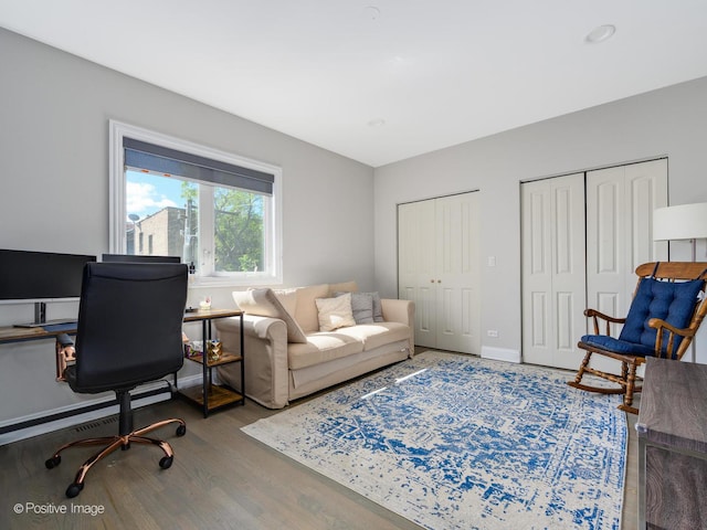 office space with wood finished floors and baseboards