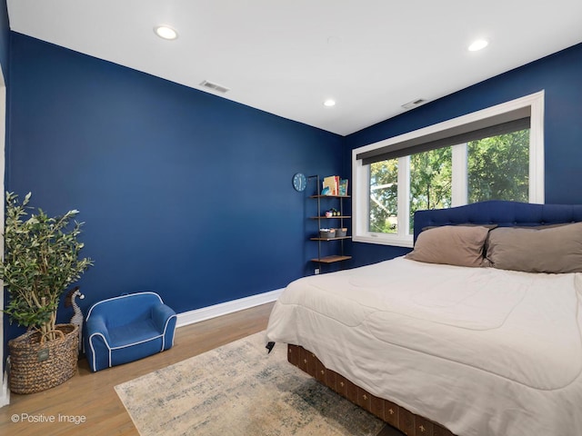 bedroom featuring visible vents, recessed lighting, baseboards, and wood finished floors