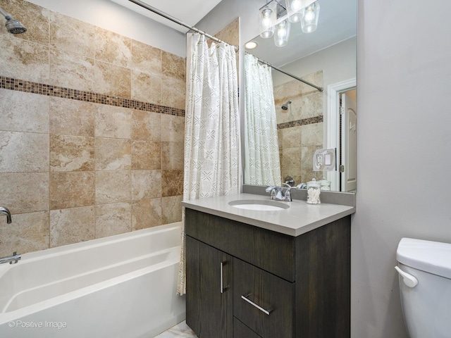 bathroom with shower / bath combo with shower curtain, toilet, and vanity