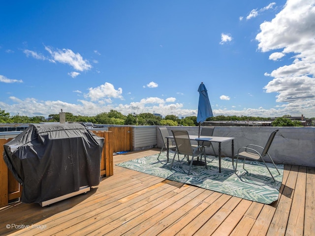 deck featuring grilling area and outdoor dining area