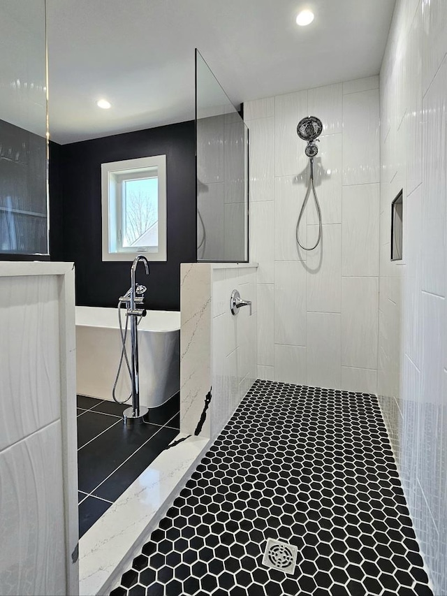 bathroom with a soaking tub, recessed lighting, and tiled shower