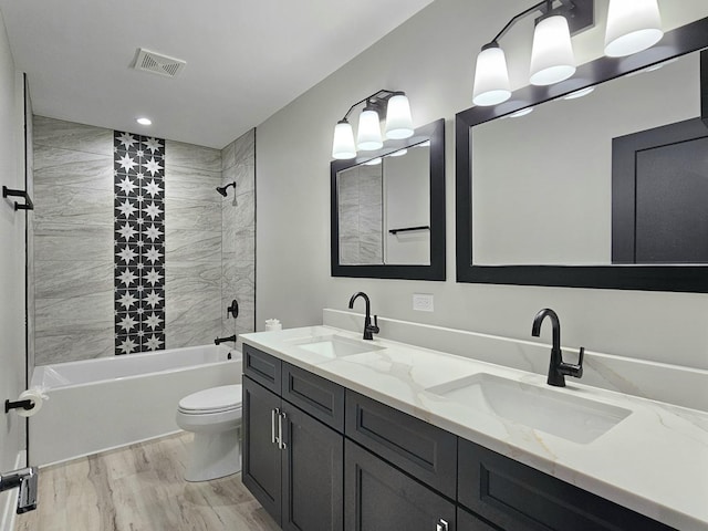 bathroom featuring visible vents, toilet,  shower combination, and a sink