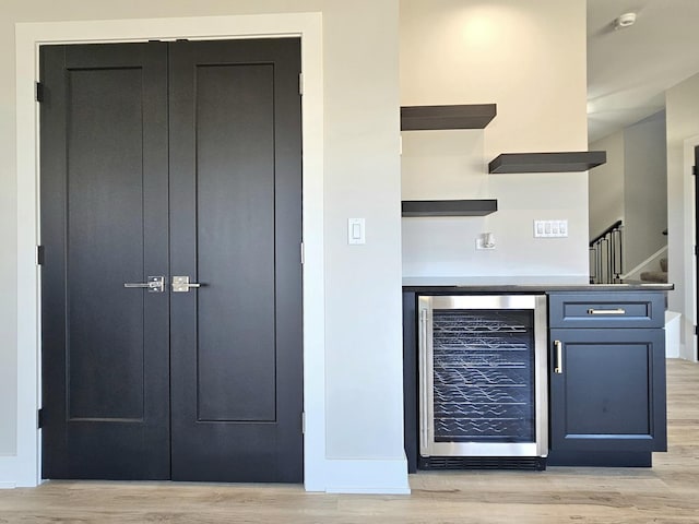 kitchen featuring wine cooler, baseboards, light wood-style floors, and open shelves