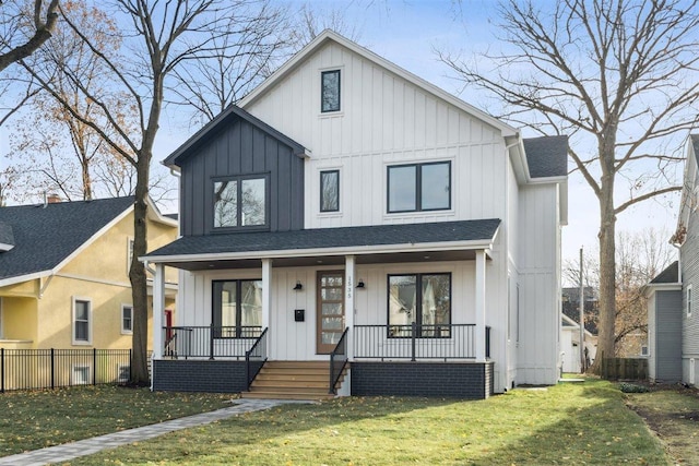 modern farmhouse style home featuring fence, roof with shingles, covered porch, board and batten siding, and a front yard