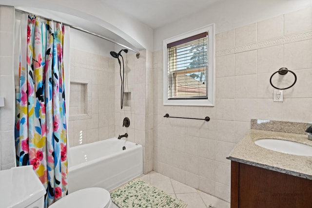 full bathroom featuring tile patterned floors, shower / bath combo with shower curtain, toilet, tile walls, and vanity