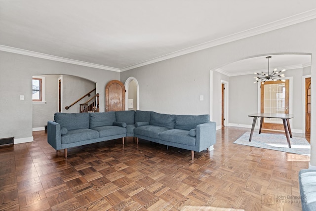 living area with arched walkways, an inviting chandelier, stairs, and baseboards