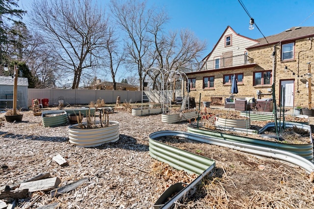 view of yard with fence and a garden