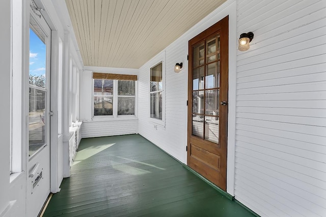 unfurnished sunroom with wooden ceiling