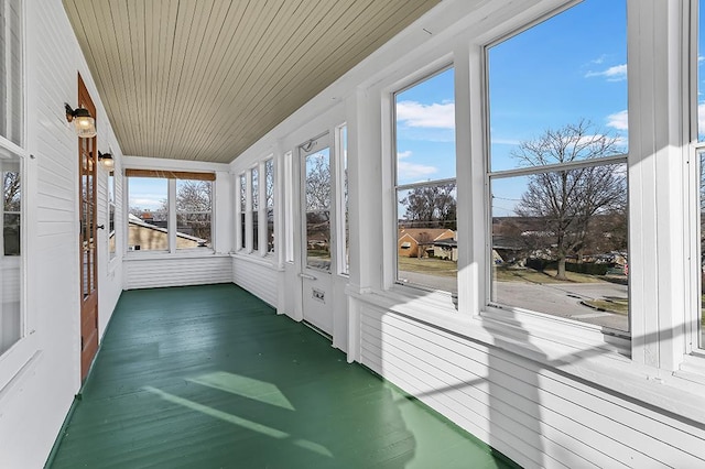 unfurnished sunroom featuring wood ceiling