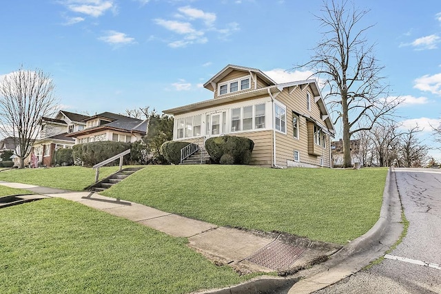 bungalow-style house featuring a front yard