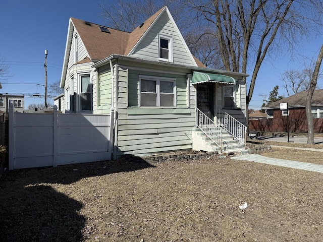 view of front facade featuring entry steps and fence