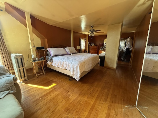 bedroom featuring radiator, ceiling fan, and hardwood / wood-style flooring