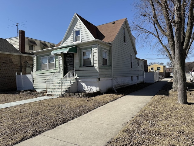 bungalow with entry steps and fence