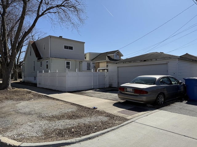 view of front of property featuring an outbuilding and fence