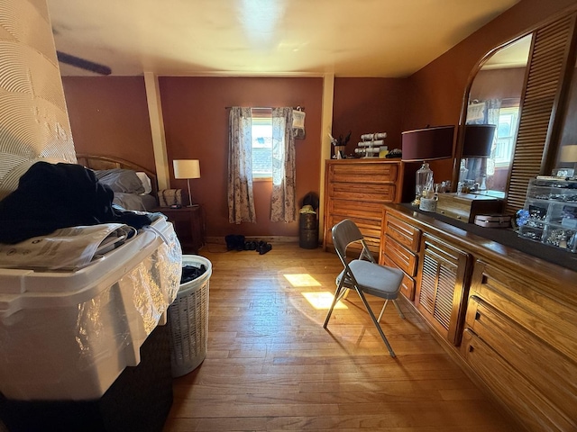 bedroom with light wood-style floors and arched walkways