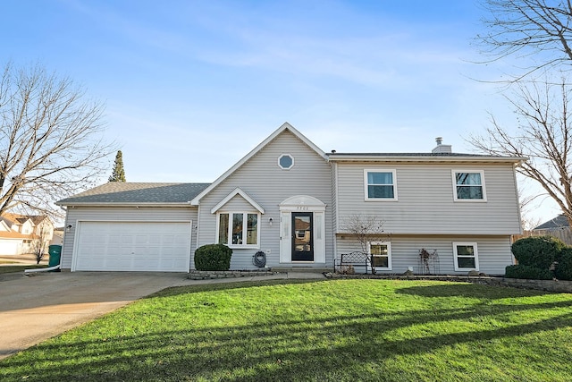 tri-level home with concrete driveway, an attached garage, a front lawn, and a chimney