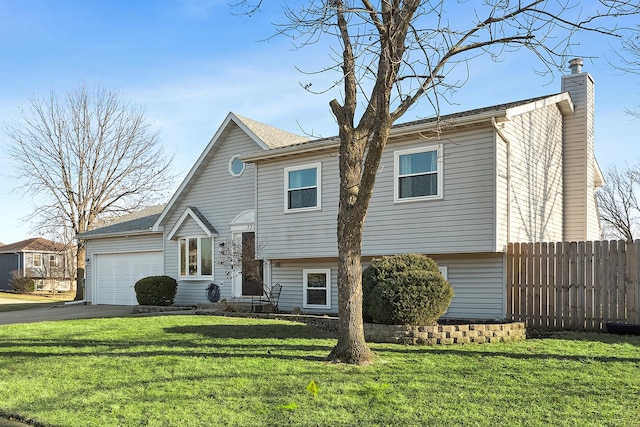 view of front of property with fence, a front yard, a chimney, driveway, and an attached garage