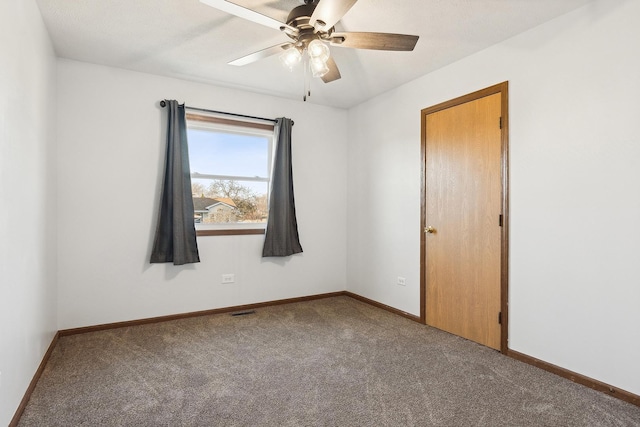 empty room featuring a ceiling fan, visible vents, carpet, and baseboards