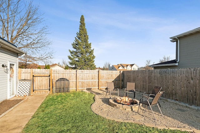 view of yard with a fire pit and a fenced backyard