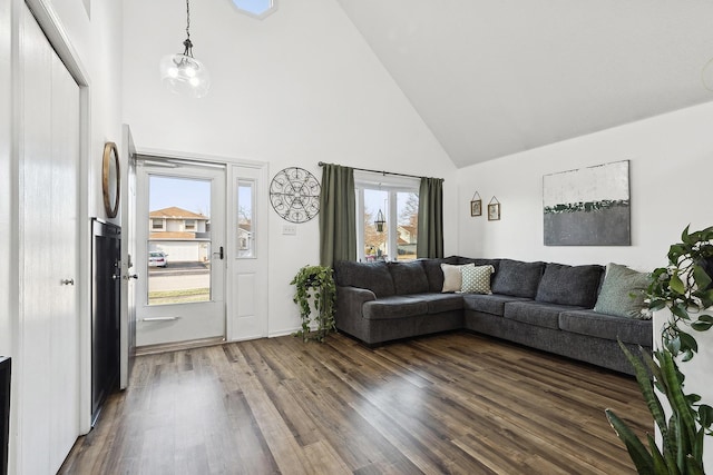 living room with high vaulted ceiling and dark wood-type flooring