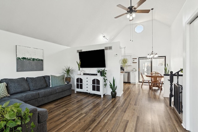 living room featuring ceiling fan with notable chandelier, visible vents, and dark wood-style flooring